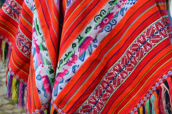 A detail of the intricate designs and vibrant colors on Andres' traditional poncho. 